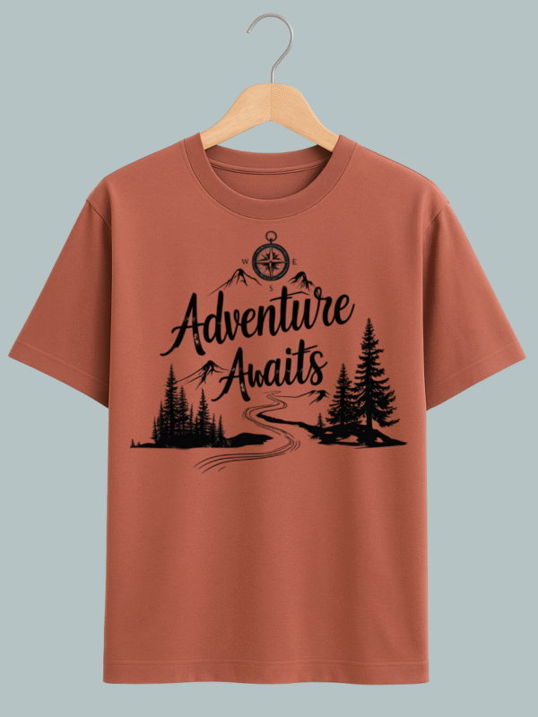 "T-shirt design featuring ‘Adventure Awaits’ text with mountain, forest, and sun illustrations — ideal for travel lovers."