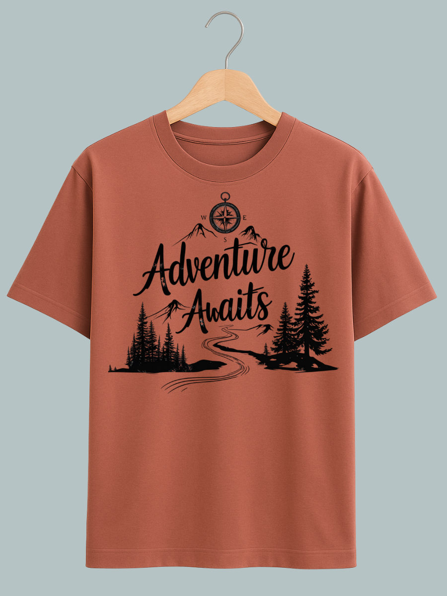 "T-shirt design featuring ‘Adventure Awaits’ text with mountain, forest, and sun illustrations — ideal for travel lovers."
